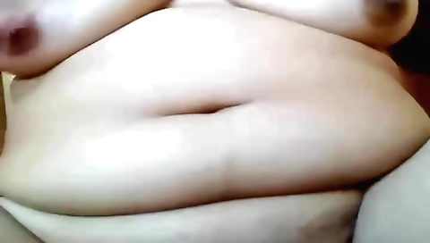 Chubby chick in a red dress masturbates on the webcam