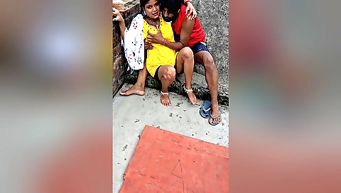 Busty brunette babe in a black dress giving a handjob