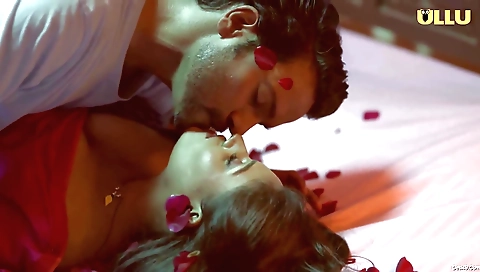 A hot brunette in a nice outfit is riding a hot man in her car